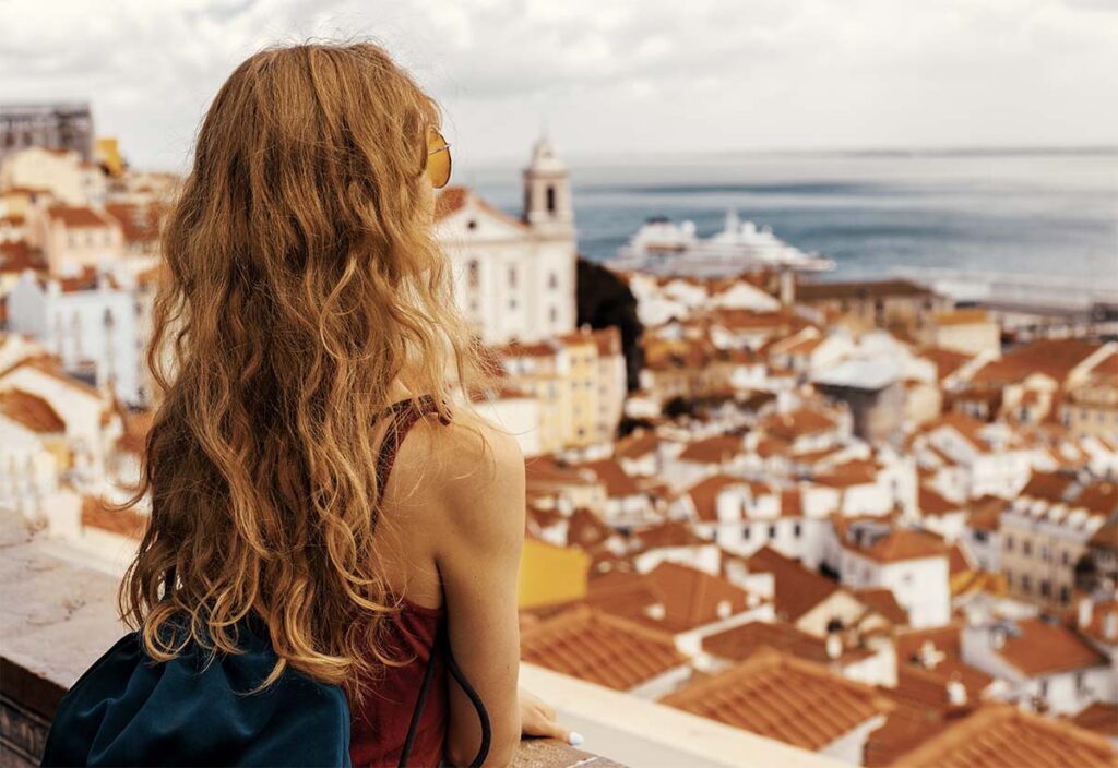 relocated woman looks over lisbon portugal